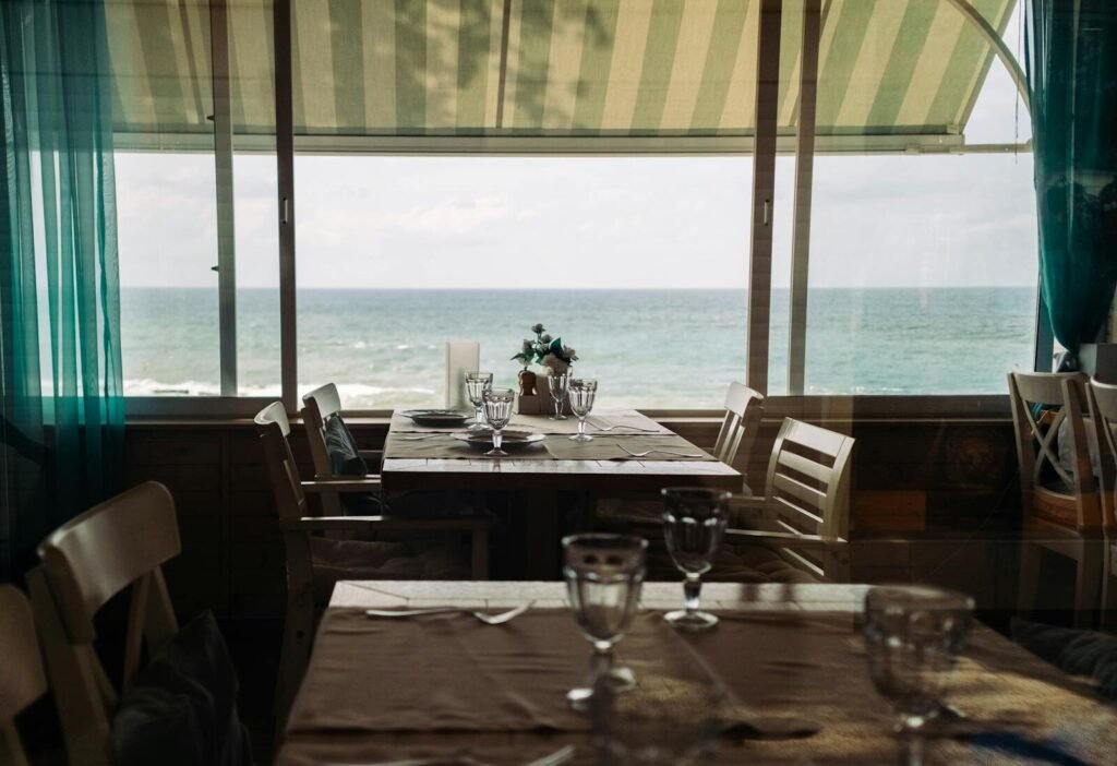 A cozy café in Sochi with a dining table overlooking the ocean, perfect for scenic dining.